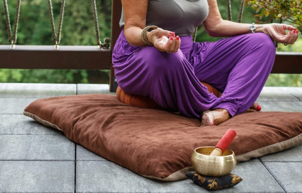 woman in purple dress sitting on gray couch